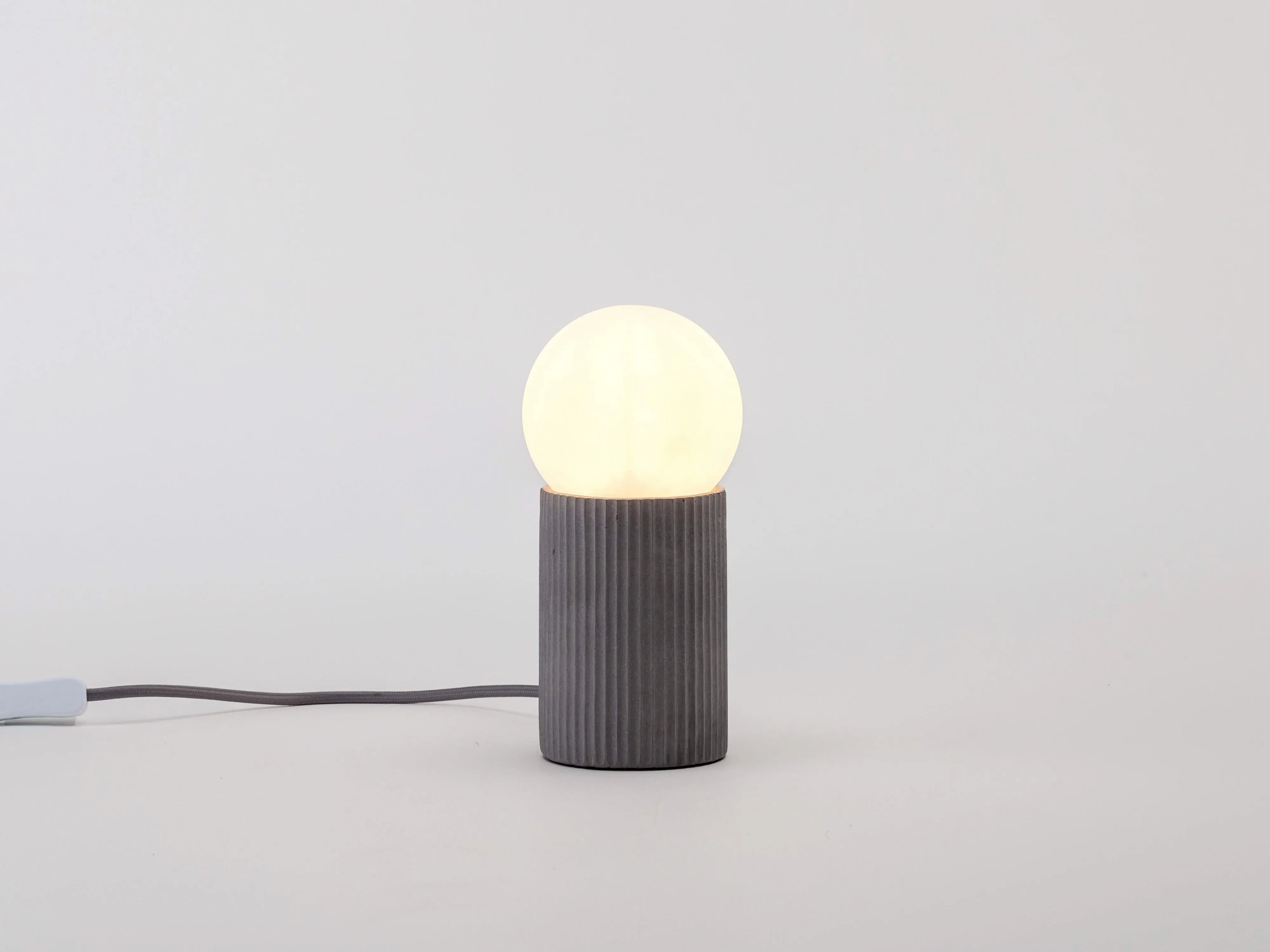 Grey concrete ribbed table lamp